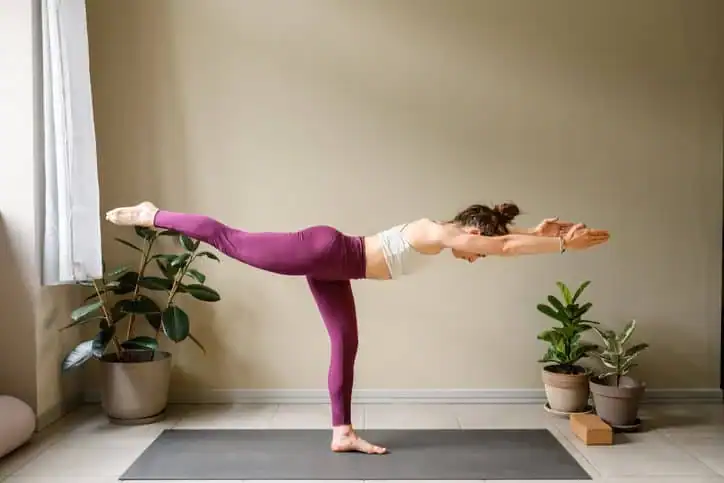 Woman doing Yoga exercise Tilbury to help with toning the body. 